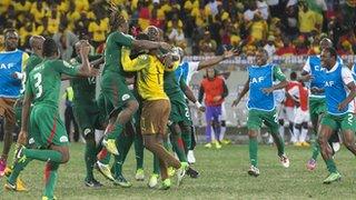 Burkinabe players celebrate their dramatic penalty shoot-out victory over Ghana