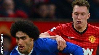 Manchester United's Phil Jones keeps a close eye on Everton's Marouane Fellaini