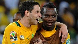 South African midfielder Dean Furman (L) celebrates his team's progression from the group stage