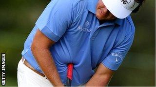 Phil Mickelson attempts a putt with a belly putter on the 13th hole green during the second round of the Deutsche Bank Championship at TPC Boston on September 3, 2011