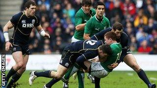 Ireland's Paddy Jackson is halted by Matthew Scott and Tim Visser