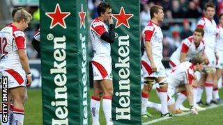 Ulster's players stand forlorn behind the posts after Chris Ashton's decisive try