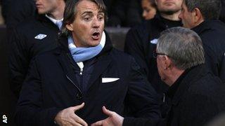 Manchester City boss Roberto Mancini shakes hands with Manchester United manager Sir Alex Ferguson