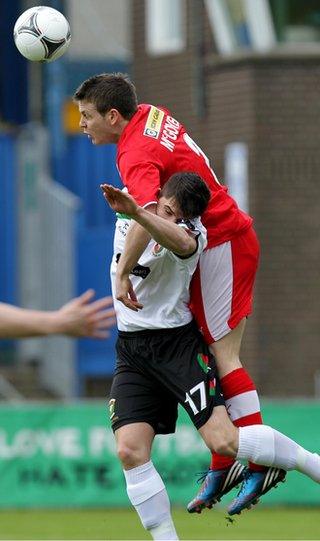 Cliftonville defender Jaimie McGovern gets above Jimmy Callacher to head the ball