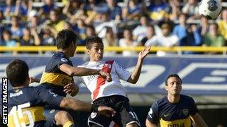 River Plate's midfielder Manuel Lanzini heads the ball to score against Boca Juniors