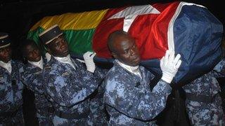 Togolese police carry the coffin of one of the victims of the 2010 Cabinda attack upon its return to Lome airport.