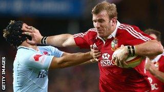 Tom Croft hands off Tom Kingston on the way to scoring for the Lions