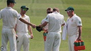 Coach Darren Lehmann (far right) helps carry the drinks