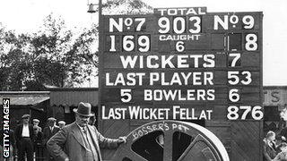 Groundsman Bosser Martin with the Oval scoreboard