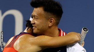 A ball boy consoles Francesca Schiavone as she slides towards defeat against Serena Williams