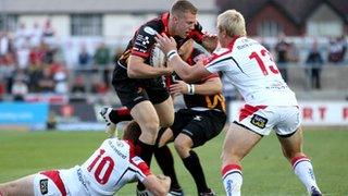 Jack Dixon is tackled by Paddy Jackson and Luke Marshall