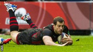 Edinburgh Rugby's Tim Visser slides in to score his side's second try of the game against Munster