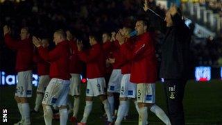 Inverness boss Terry Butcher and his players salute their travelling fans in darkness