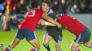 Glasgow captain Chris Cusiter is challenged by Munster's Casey Laulala and Mike Sherry (right)