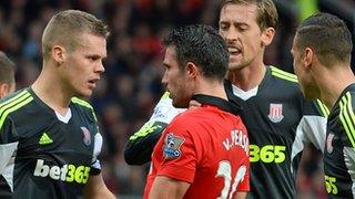 Manchester United striker Robin van Persie argues with Stoke defender Ryan Shawcross