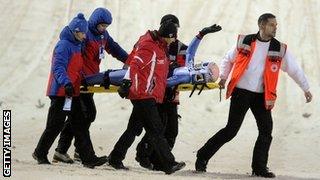 Ski jumper Andreas Kofler is stretchered away after a crash