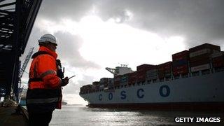 A marine Supervisor monitors the departure of a container ship at Felixstowe