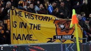 Hull fans display a banner during the win over Liverpool in support of the club staying as Hull City AFC