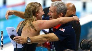 Rebecca Adlington of Great Britain hugs her coach Bill Furniss after winning the bronze in the Women's 400m Freestyle final on Day 2 of the London 2012 Olympic Games.