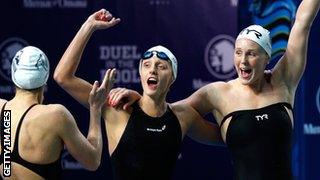 Aliaksandra Herasimenia of Belarus, Fancesca Halsall of Great Britain, and Jeanette Ottesen of Denmark celebrate after winning the Women's 4x100m Freestyle during Duel in the Pool.