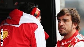 Fernando Alonso of Spain and Ferrari talks with his race engineer Andrea Stella on the pitwall as he prepares to drive during the final practice session.