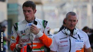 Force India's Scottish driver Paul Di Resta walks in the pits during the third practice session at the Yas Marina circuit in Abu Dhabi on November 2, 2013 ahead of the Abu Dhabi Formula One Grand Prix.