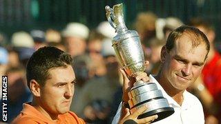 Thomas Bjorn looking at Ben trophy hoisting aloft the claret jug in 2003.