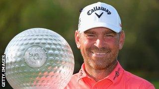 Thomas Bjorn holding the 2013 Sun City trophy.