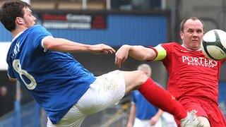 Richard Clarke in Windsor Park action against Philip Lowry of Linfield