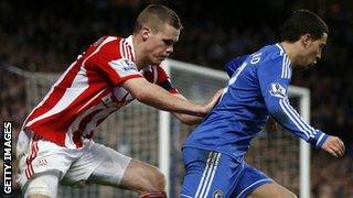 Eden Hazard is challenge by Ryan Shawcross