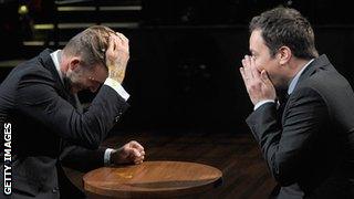 David Beckham (left) gets egg in his hair during a game an American chatshow