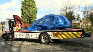 A vehicle being taken away by a recovery truck following a collision in Macclesfield, Cheshire