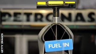 A 'Fuel in' sign hangs on the car of Mercedes GP's German driver Nico Rosberg in the pits at the Bahrain international circuit on March 13, 2010 in Manama, during the third free practice.