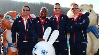 John Jackson, Joel Fearon, Stuart Benson and Bruce Tasker of the Great Britain Bobsleigh team pose with the mascots at the Rosa Khutor mountain village cluster on