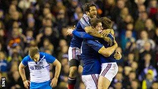 Duncan Weir cannot bear to look as France celebrate at the final whistle