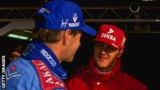 Gerhard Berger (left) and Michael Schumacher in discussion during their racing days