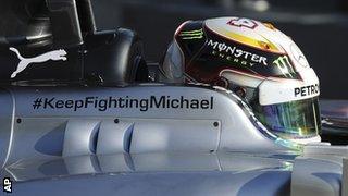 A message of support for Michael Schumacher adorns the side of Mercedes driver Lewis Hamilton's car