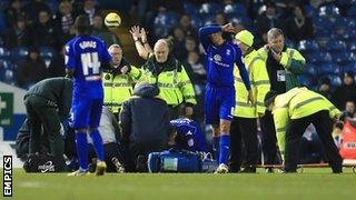 Will Packwood prepares to be loaded onto the stretcher at Elland Road, January 2013