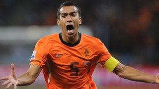 Giovanni van Bronckhorst celebrates after scoring for Netherlands against Uruguay