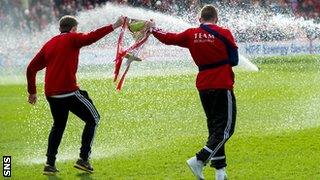 Aberdeen's Peter Pawlett and Jonny Hayes have to be on their toes to avoid the sprinklers pre-match