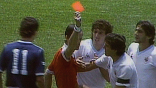 Referee Joel Quiniou sends off Uruguay's Jose Batista against Scotland