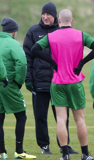 Hibs manager Terry Butcher talks to his players during training