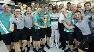 Lewis Hamilton (centre) celebrates after winning the Bahrain GP