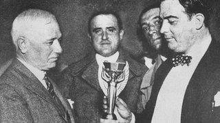 Fifa president Jules Rimet hands over the trophy to Uruguay