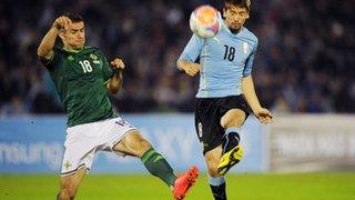 Aaron Hughes in action during the international friendly against Uruguay