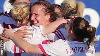 Kim Little celebrates with team-mates after scoring Scotland's first goal