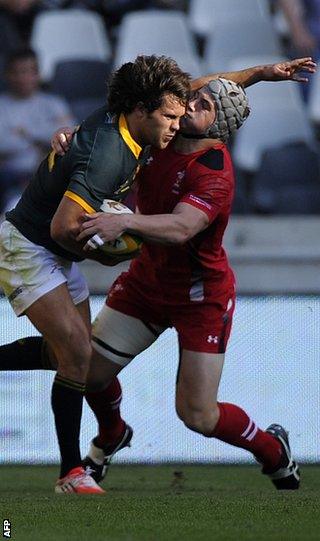 South Africa's Jan Serfontein is tackled by Jonathan Davies