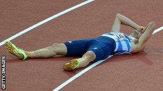 Dai Greene lies on the track looking desolate.