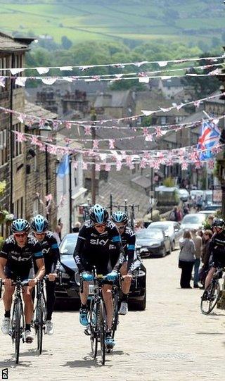 Chris Froome (front right ) rides alongside Richie Porte as the Sky riders climb the cobbled hill at Haworth in preparation for the Tour