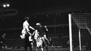 Slovan Bratislava keeper Viliam Schrojf clears a corner during the quarter final of the European Cup-Winners' Cup at White Hart Lane, which Tottenham Hotspur won 6-0. Jumping with him are Frank Saul (left) and John White, March 1963.